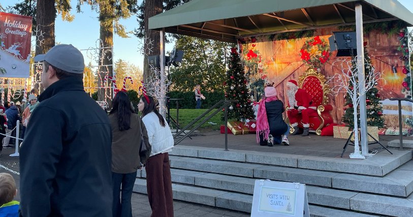 Santa leans over to speak to a child